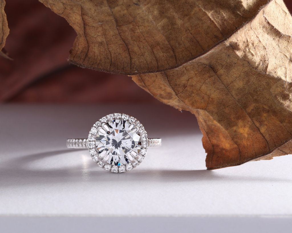 classic halo diamond engagement ring on white table